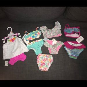 4 swim suits and one swim diaper